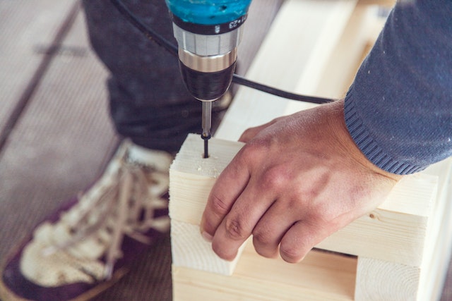 contractor%20drilling%20into%20a%20piece%20of%20wood%20to%20make%20a%20repair